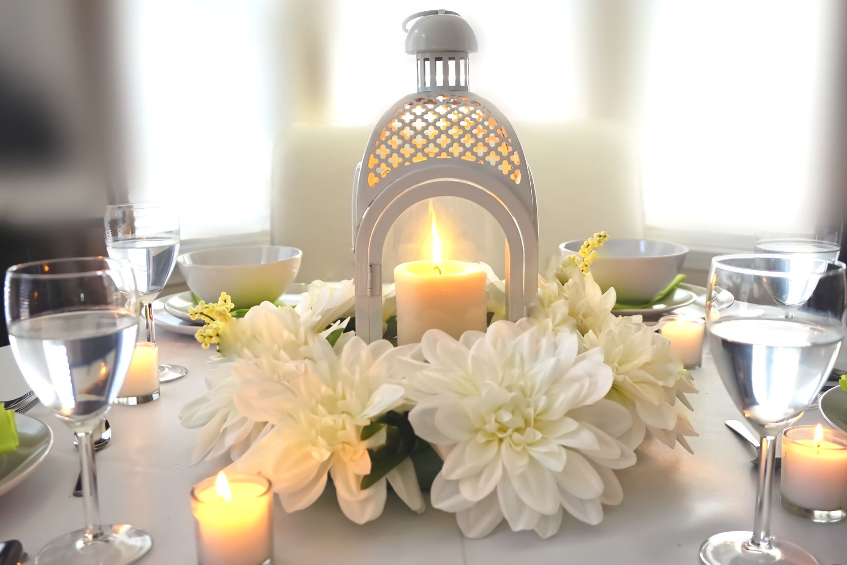 Dais table with lantern and floral decor.