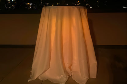 Highboy pub table with draped cloth and amber lighting. Table is for rent in Queens  New York